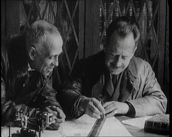 Portuguese Airmen Sacadura Cabral and Gago Coutinho Looking at a Map, 1922. Creator: British Pathe Ltd.