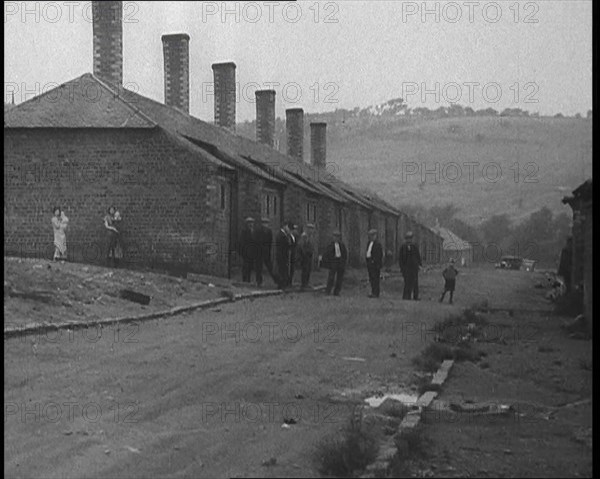 Group of Men, Women and Children Standing Around on a Street, 1933. Creator: British Pathe Ltd.