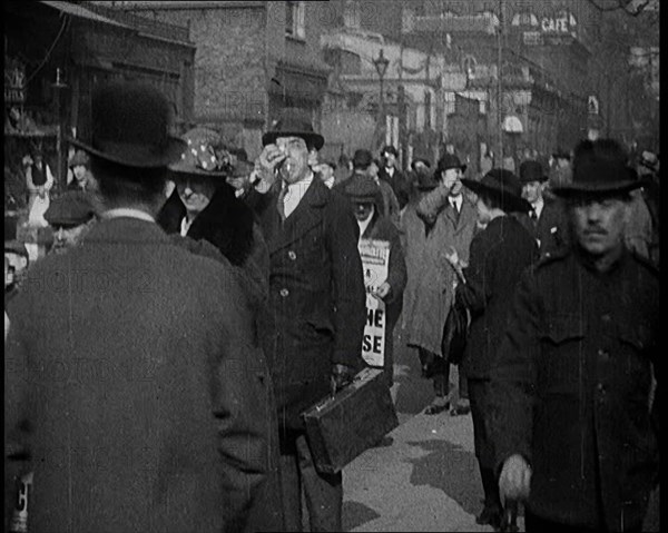 Men Wearing 'Pathe Gazette' Sandwich Boards Handing Out Pieces of Polaroid Film to Crowds..., 1921. Creator: British Pathe Ltd.