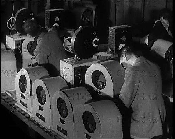 Male and Female Civilians Building Radio Wireless Sets in a Factory, 1931. Creator: British Pathe Ltd.