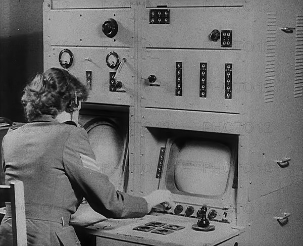 A Woman Operating a Radio, 1940. Creator: British Pathe Ltd.