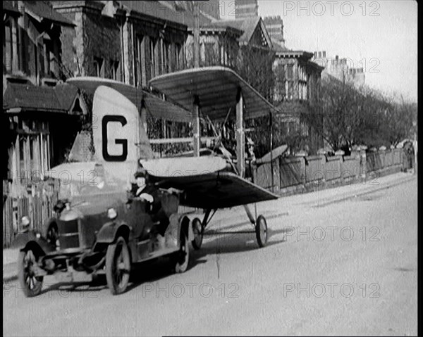 A Car Towing a Small Aeroplane With Its Wings Folded Over Along the Road, 1924. Creator: British Pathe Ltd.