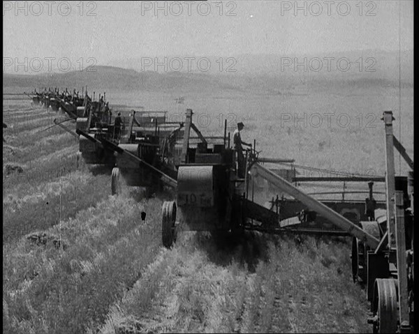 Combine Harvesters Crossing Large Fields, 1932. Creator: British Pathe Ltd.