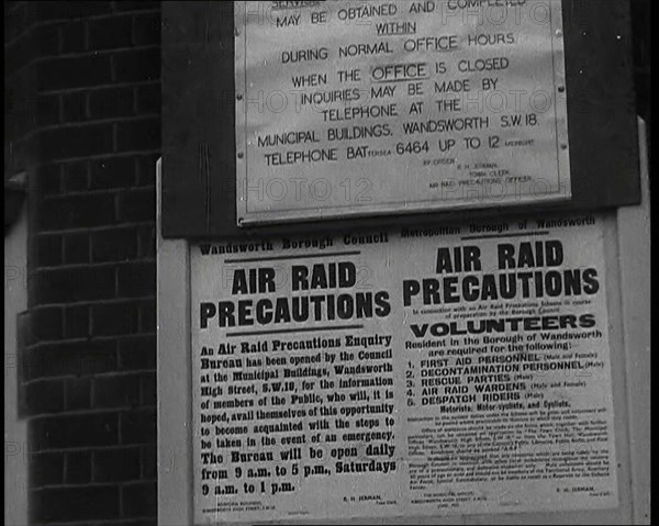 Notices Containing Information About 'Air Raid Precautions' and Asking For Volunteers..., 1938. Creator: British Pathe Ltd.