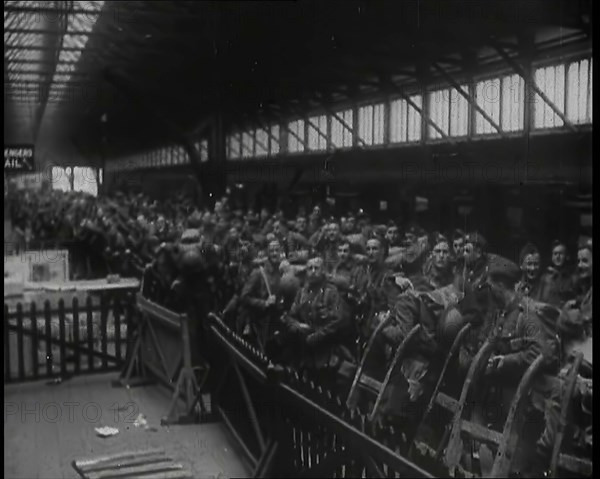 Male Members of the British Expeditionary Force Waiting at  a Large Railway Station Before..., 1939. Creator: British Pathe Ltd.