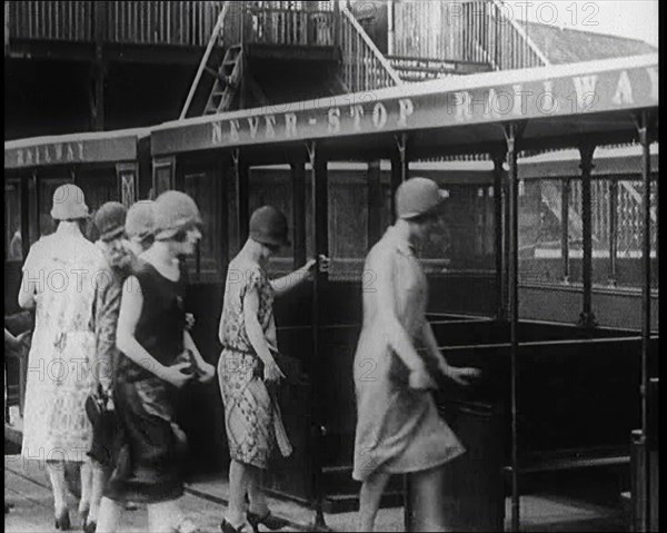 A Group of Female Civilians Board a Carriage of the 'Never Stop Railway', 1924. Creator: British Pathe Ltd.