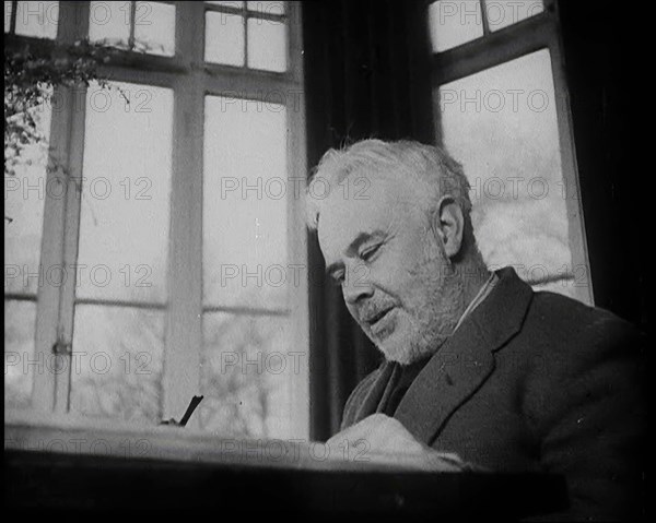 C.E.M Joad Sitting Down at His Desk, 1930s. Creator: British Pathe Ltd.