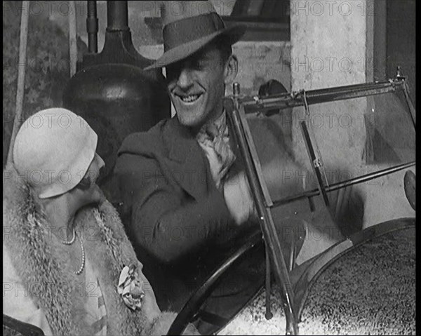 Jack Hulbert Climbing Into a Car And Getting His Fingers Stuck in Windscreen, 1920s. Creator: British Pathe Ltd.