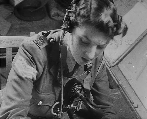 A Woman Operating a Radio, 1940. Creator: British Pathe Ltd.