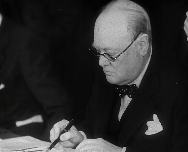 Winston Churchill Signing an Agreement Allowing the USA to use British Naval Bases in..., 1941. Creator: British Pathe Ltd.