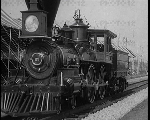 Old Locomotive Travelling Along the Tracks in Front of an Audience of Civilians in a Show..., 1920s. Creator: British Pathe Ltd.