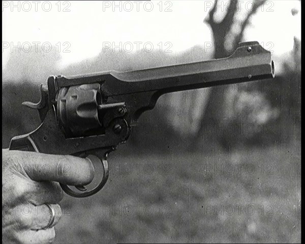 Scene from the Feature Film 'The White Sheik'. A Pistol Being Held By a Man With His Finger...,1920s Creator: British Pathe Ltd.