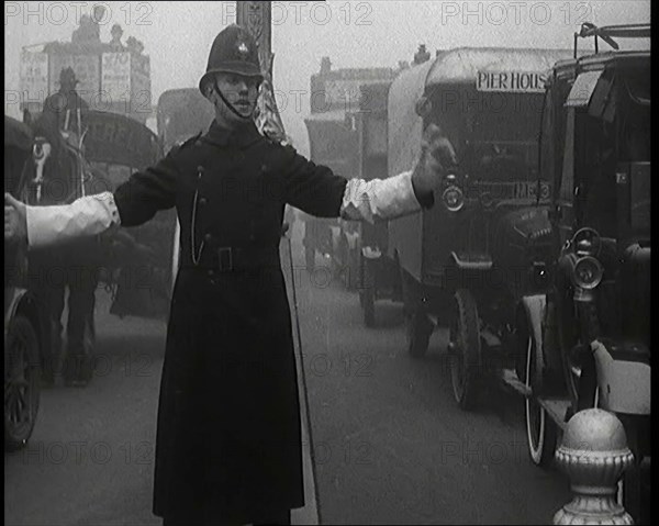 Male British Police Officer Controlling the Traffic On the Streets of London, 1920s. Creator: British Pathe Ltd.