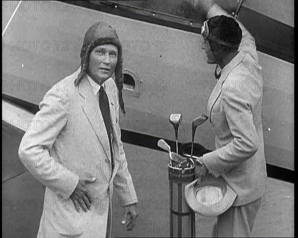 Two Golfers With Gold Clubs Enter a Gyrocopter, 1932. Creator: British Pathe Ltd.