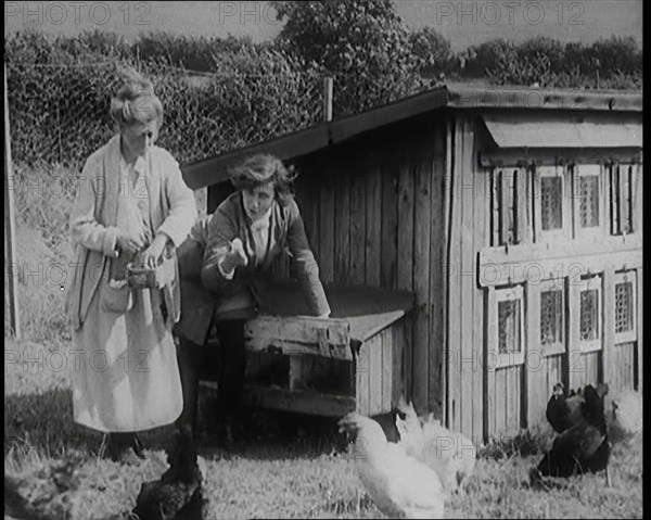 Stage Star Syndey Fairbrother Collecting Hen Eggs on Her Farm, 1920s. Creator: British Pathe Ltd.