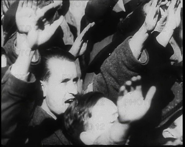 A Close up of Austrian Civilians Performing the German Nazi Salute, 1938. Creator: British Pathe Ltd.