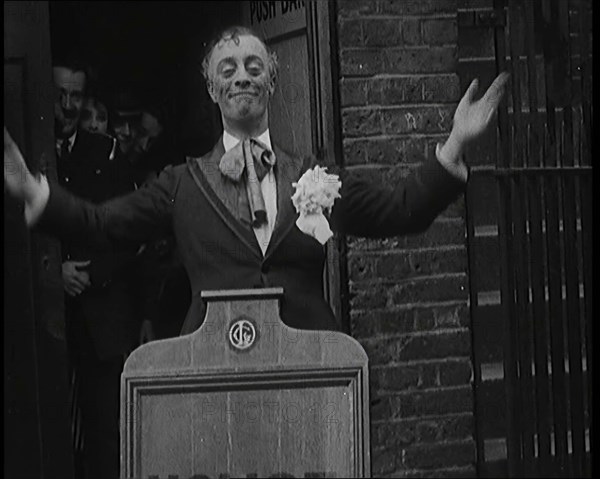 The Actor Leslie Henson Rising Spookily up from Behind a Mock Gravestone, 1920s. Creator: British Pathe Ltd.