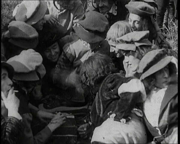 Crowds of Female Actors Wearing Period Costumes Smoking Cigarettes Whilst Filming..., 1920s. Creator: British Pathe Ltd.