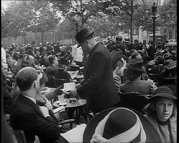 French Police Checking People's Papers Outside a Cafe in Paris, 1940. Creator: British Pathe Ltd.