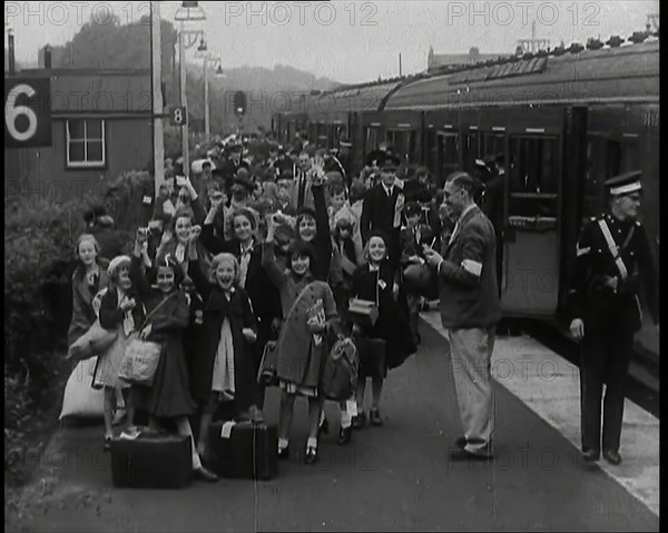 British Male and Female Evacuees on the Platform of a Small Station in the British Country..., 1939. Creator: British Pathe Ltd.