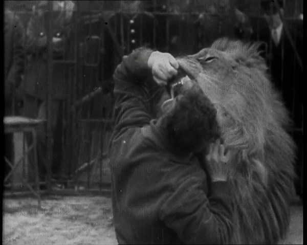 Man Sticking his Head in a Lion’s Mouth, 1930s. Creator: British Pathe Ltd.