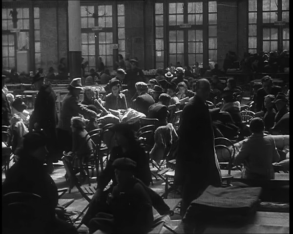 Dutch Refugees Sitting and Eating at a Reception Centre in the United Kingdom, 1940. Creator: British Pathe Ltd.