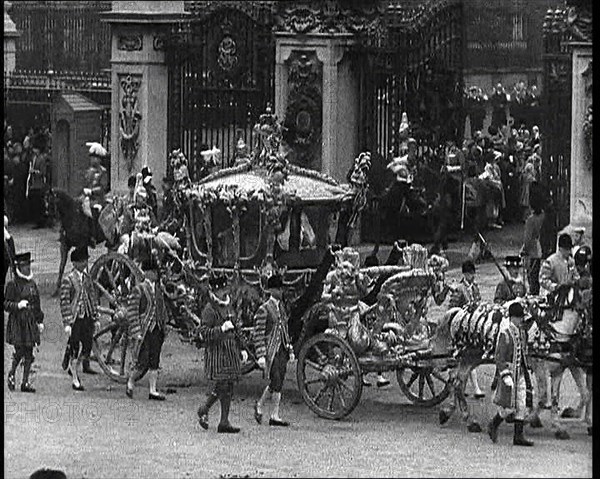 The Royal Coach, Horses, and Procession Filing Out of the Gates and Turning Left at the..., 1937. Creator: British Pathe Ltd.