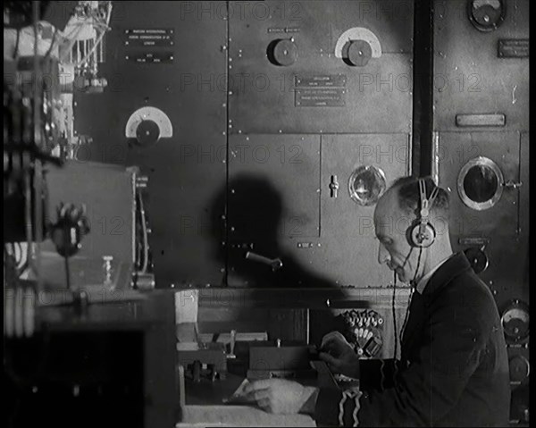 Interior of a Ship at Sea With Man at Work Operating a Communication System, 1920s. Creator: British Pathe Ltd.