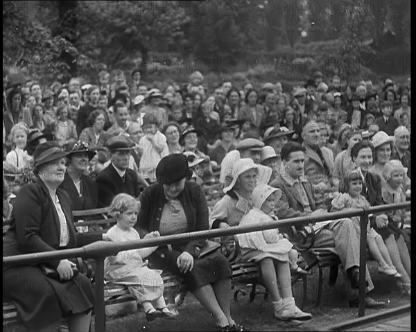 British People Watching Chimpanzees Having a Tea Party at the Zoo, 1940. Creator: British Pathe Ltd.