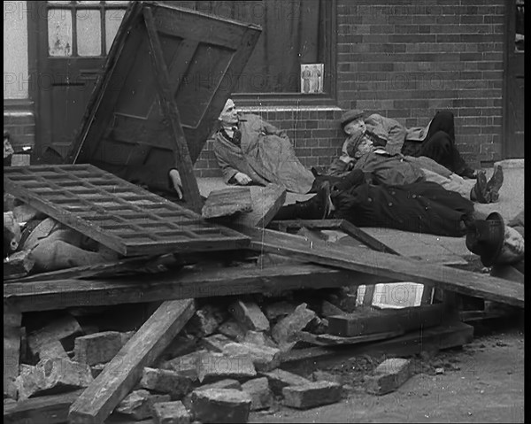 British People Acting Out Bomb attacks and Crashed German Planes, Lying Under Rubble, 1940. Creator: British Pathe Ltd.