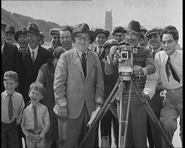 A Group of People Laughing as They Are Watch the Film Being Made from Behind a Camera, 1920s. Creator: British Pathe Ltd.