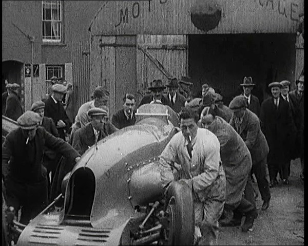 A Crowd of Civilians Watching a Group of Civilians Wheeling Malcolm Campbell's 'Bluebird'..., 1927. Creator: British Pathe Ltd.