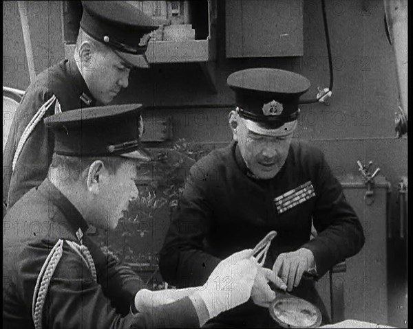 Three Male Japanese Naval Officers in Uniform Discuss Military Plans, 1937. Creator: British Pathe Ltd.