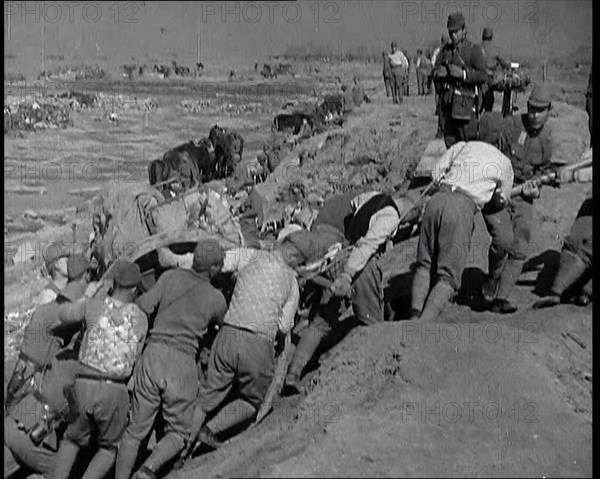 Male Japanese Soldiers Hauling a Cart up a Beach Near Shanghai, 1937. Creator: British Pathe Ltd.