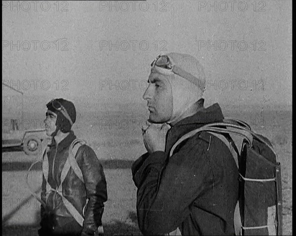 Pilot and Rear Gunner of Biplane Readying Themselves To Board Their Plane With One Adjusting...,1937 Creator: British Pathe Ltd.