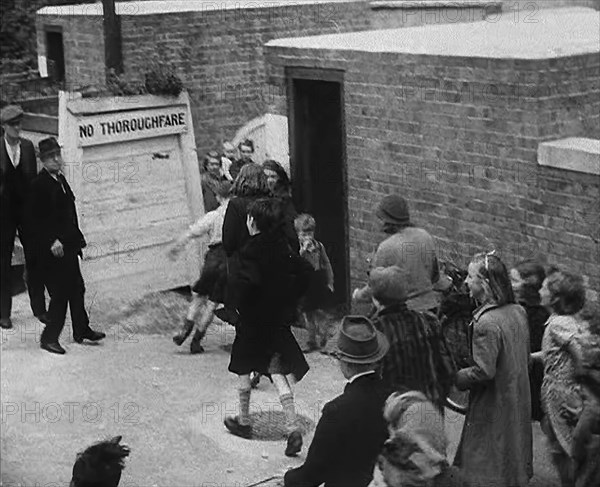 Civilians Entering an Air Raid Shelter to Escape German Shelling, 1940. Creator: British Pathe Ltd.