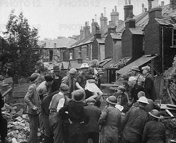 An Injured Child Being Carried from a Bombed Out House, 1940. Creator: British Pathe Ltd.