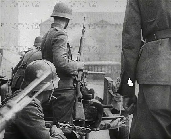 German Soldiers in a Bomb-Damaged Town, 1941. Creator: British Pathe Ltd.