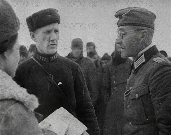 Two Russian Soldiers Talking to a German Prisoner of War, 1941. Creator: British Pathe Ltd.