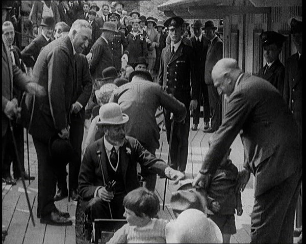 King George V of the United Kingdom Sitting On a Model Train With a Crowd of People Watching, 1924. Creator: British Pathe Ltd.