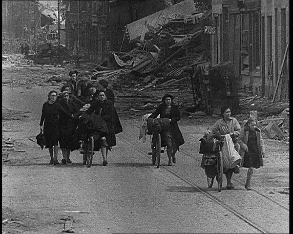 Belgian Refugees Fleeing Their Town Along Bomb Damaged Road, 1940. Creator: British Pathe Ltd.