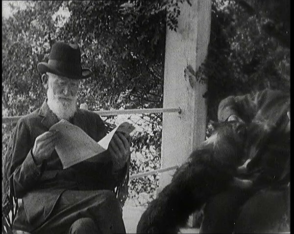 George Bernard Shaw and a Male Civilian Sitting in a Garden, 1920s. Creator: British Pathe Ltd.