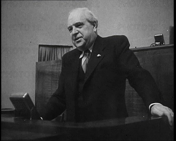 Male Representative of the League of Nations Speaking at Lectern in Front of Microphone, 1937. Creator: British Pathe Ltd.