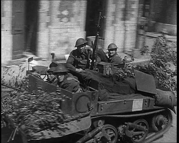 British Expeditionary Force Retreating Through Belgian Town on Vehicles, 1940. Creator: British Pathe Ltd.