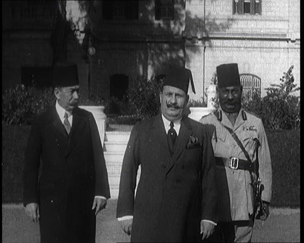 King Faud I Accompanied by One Male Civilian and One Male Soldier Walking Down Steps, 1924. Creator: British Pathe Ltd.