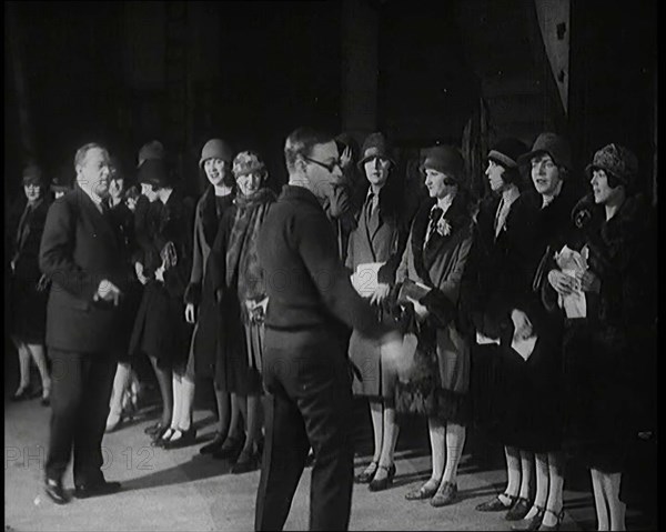 The Producer Julian Wylie Inspecting Young Prospective Female Stage Performers Standing..., 1920s. Creator: British Pathe Ltd.