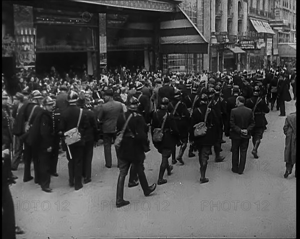 French Police Checking People's Papers Outside a Cafe in Paris, 1940. Creator: British Pathe Ltd.