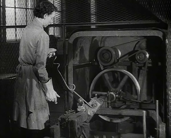 A Woman Using Factory Machinery, 1942. Creator: British Pathe Ltd.