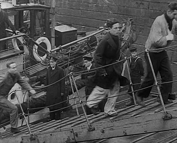 Crew of the Destroyed Bismarck Walking up a Gangplank Into a British Ship, 1943. Creator: British Pathe Ltd.