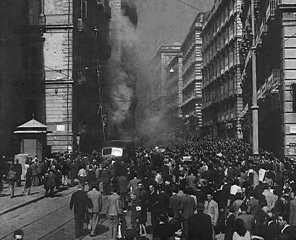 Italian Civilians Moving Slowly Through Bomb-Damaged Naples, 1943-1944. Creator: British Pathe Ltd.